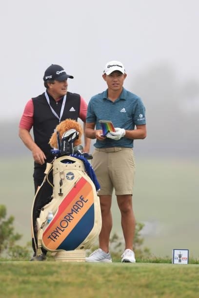 Collin Morikawa of the United States looks at his yardage book on the fifth tee during a practice round prior to the start of the 2021 U.S. Open at...