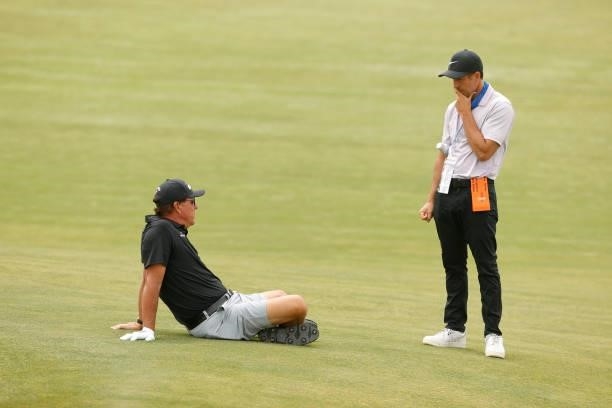 Phil Mickelson of the United States sits and talks with coach Chris Como during a practice round prior to the start of the 2021 U.S. Open at Torrey...