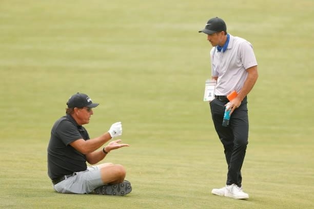 Phil Mickelson of the United States sits and talks with coach Chris Como during a practice round prior to the start of the 2021 U.S. Open at Torrey...