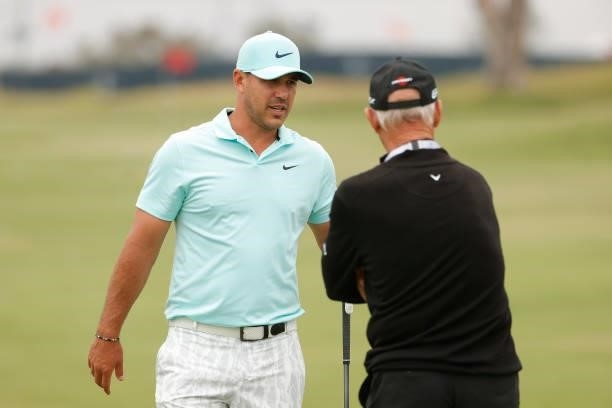 Brooks Koepka of the United States talks with coach Pete Cowen during a practice round prior to the start of the 2021 U.S. Open at Torrey Pines Golf...
