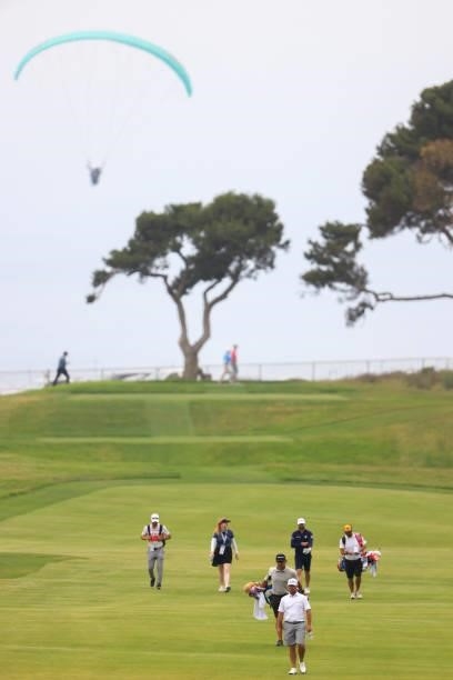 Will Zalatoris of the United States, Mario Carmona of Mexico, amateur Pierceson Coody of the United States walk up the 12th fairway during a practice...