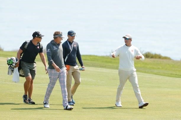 Ian Poulter of England and Adam Scott of Australia talk as they walk the fourth hole during a practice round prior to the start of the 2021 U.S. Open...