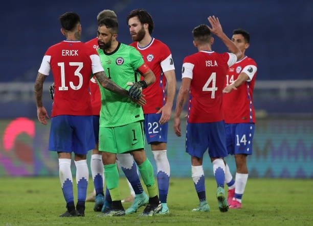 Erick Pulgar and Claudio Bravo goalkeeper of Chile embrace after a Group A match between Argentina and Chile at Estadio Olímpico Nilton Santos as...