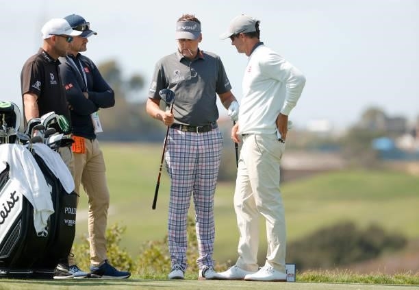 Ian Poulter of England and Adam Scott of Australia look at a driver on a tee during a practice round prior to the start of the 2021 U.S. Open at...