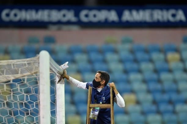 Worker wipes the goal before a Group A match between Paraguay and Bolivia at Estádio Olímpico as part of Copa America Brazil 2021 on June 14, 2021 in...