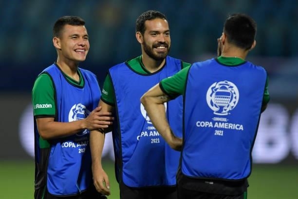 Erwin Junior Sanchez of Bolivia talks with teammates before a Group A match between Paraguay and Bolivia at Estádio Olímpico as part of Copa America...