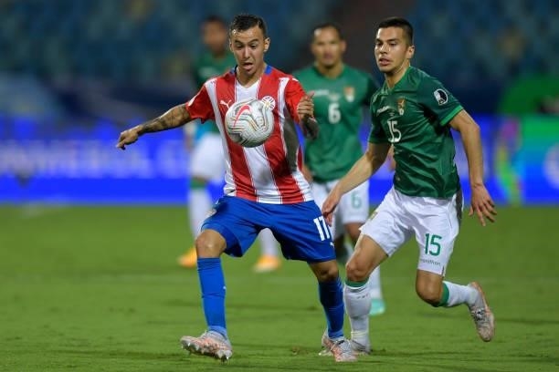 Alejandro Romero Gamarra of Paraguay competes for the ball with Boris Cespedes of Bolivia during a Group A match between Paraguay and Bolivia at...