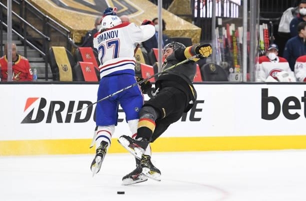 Alexander Romanov of the Montreal Canadiens hits Alex Pietrangelo of the Vegas Golden Knights during the first period in Game One of the Stanley Cup...