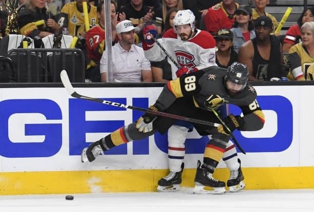 Alex Tuch of the Vegas Golden Knights hits Phillip Danault of the Montreal Canadiens during the first period in Game One of the Stanley Cup...