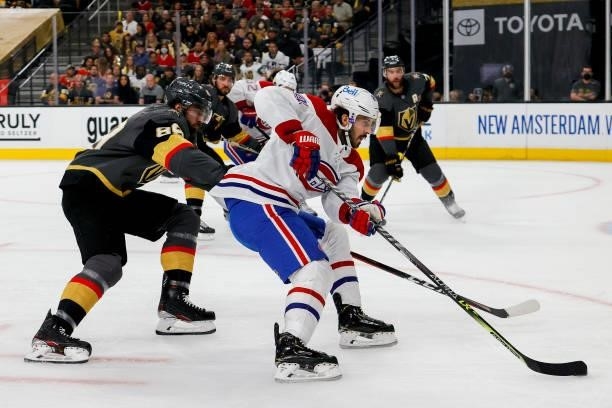 Phillip Danault of the Montreal Canadiens is defended by Alex Tuch of the Vegas Golden Knights during the first period in Game One of the Stanley Cup...