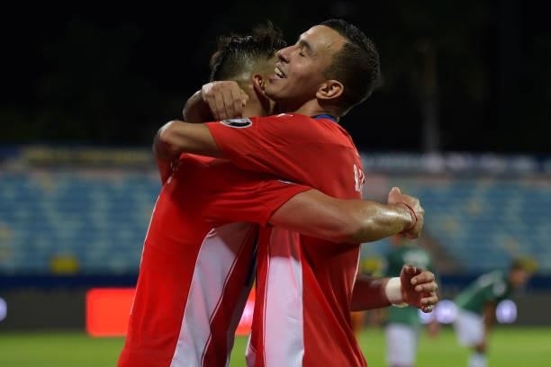 Angel Romero of Paraguay celebrates with teammate Alejandro Romero Gamarra after scoring the third goal of his team during a Group A match between...