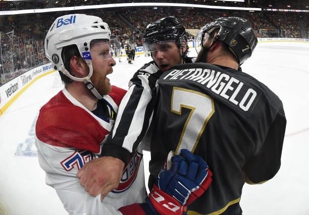 Alex Pietrangelo of the Vegas Golden Knights fights with Brett Kulak of the Montreal Canadiens during the first period in Game One of the Stanley Cup...