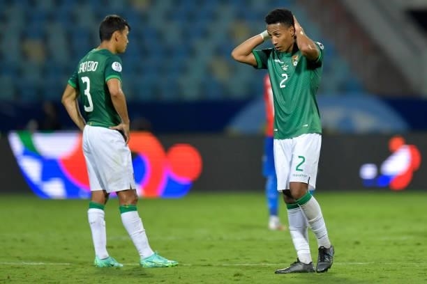 Jose Sagredo and Jairo Quinteros of Bolivia react after losing a Group A match between Paraguay and Bolivia at Estádio Olímpico as part of Copa...