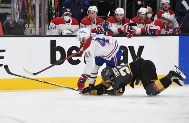 Shea Theodore of the Vegas Golden Knights trips Paul Byron of the Montreal Canadiens during the second period in Game One of the Stanley Cup...