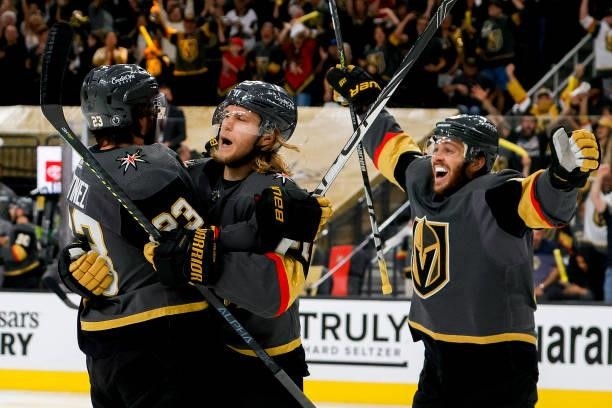 Alec Martinez of the Vegas Golden Knights is congratulated by William Karlsson and Jonathan Marchessault after scoring a goal against the Montreal...