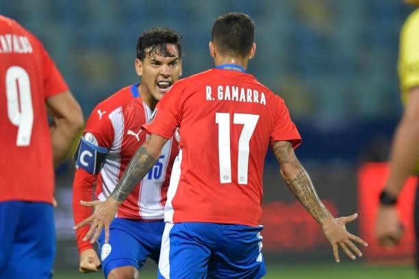 Alejandro Romero Gamarra of Paraguay celebrates with teammate Gustavo Gomez after scoring the first goal of his team during a Group A match between...