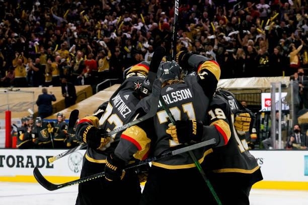 Alec Martinez of the Vegas Golden Knights is congratulated by his teammates after scoring a goal against the Montreal Canadiens during the second...