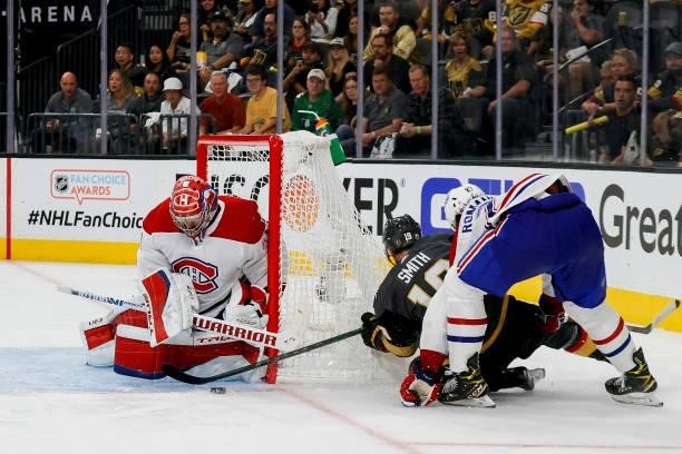 Carey Price of the Montreal Canadiens makes a save against Reilly Smith of the Vegas Golden Knights as Alexander Romanov of the Canadiens defends...
