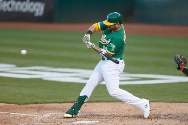 Mitch Moreland of the Oakland Athletics hits a two-run single in the bottom of the third inning against the Los Angeles Angels at RingCentral...