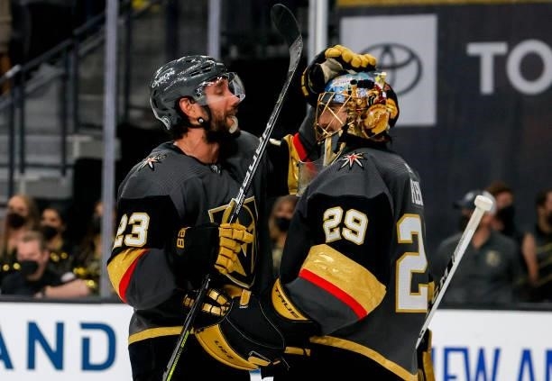 Alec Martinez and Marc-Andre Fleury of the Vegas Golden Knights celebrate the team's 4-1 victory against the Montreal Canadiens in Game One of the...