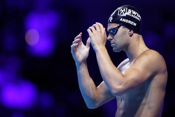 Michael Andrew of the United States competes in a semifinal heat for the Men’s 100m backstroke during Day Two of the 2021 U.S. Olympic Team Swimming...