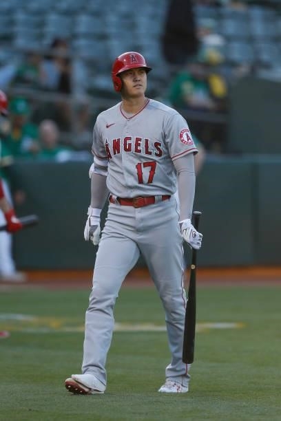 Shohei Ohtani of the Los Angeles Angels looks on after striking out in the top of the first inning against the Oakland Athletics at RingCentral...