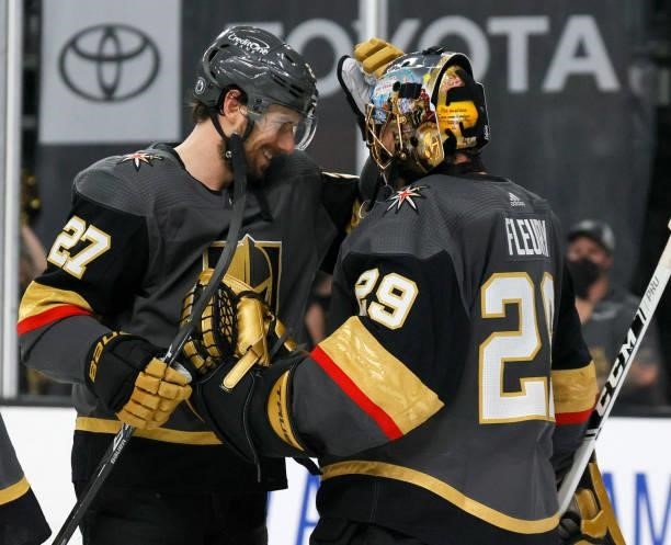 Shea Theodore and Marc-Andre Fleury of the Vegas Golden Knights celebrate on the ice after the team's 4-1 victory over the Montreal Canadiens in Game...