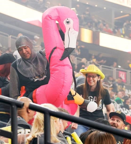 Fan wearing a knight outfit and an inflatable pink flamingo and a fan wearing a cowboy hat arrive at Game One of the Stanley Cup Semifinals during...