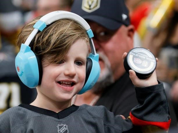 Fan shows off a puck during warmups before Game One of the Stanley Cup Semifinals during the 2021 Stanley Cup Playoffs between the Montreal Canadiens...
