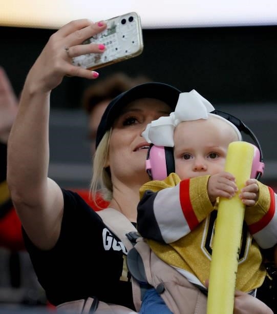 Fan takes a selfie with an infant holding a glow stick before Game One of the Stanley Cup Semifinals during the 2021 Stanley Cup Playoffs between the...