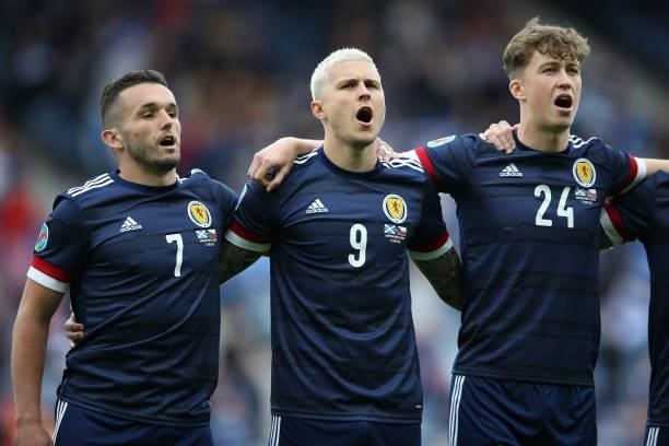 John McGinn, Lyndon Dykes and Jack Hendry of Scotland sing the national anthem during the UEFA Euro 2020 Championship Group D match between Scotland...