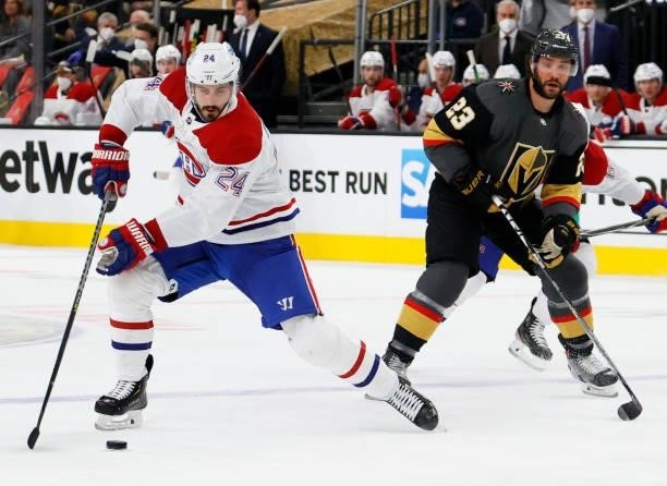Phillip Danault of the Montreal Canadiens skates with the puck against Alec Martinez of the Vegas Golden Knights in the first period in Game One of...