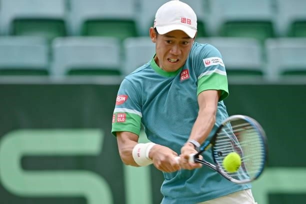 Kei Nishikori of Japan plays a backhand in his match against Ricardas Berkankis of Lithuania during day 4 of the Noventi Open at OWL-Arena on June...