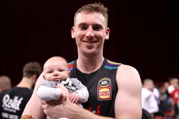 Mitch McCarron of Melbourne United poses with his baby Oslo as he celebrates victory during game three of the NBL Semi-Final Series between Melbourne...