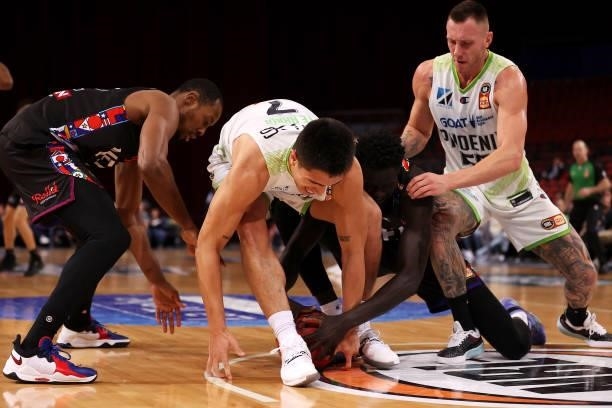 Scotty Hopson and Jo Lual-Acuil of Melbourne United compete for the ball with Reuben Te Rangi and Mitch Creek of the Phoenix during game three of the...