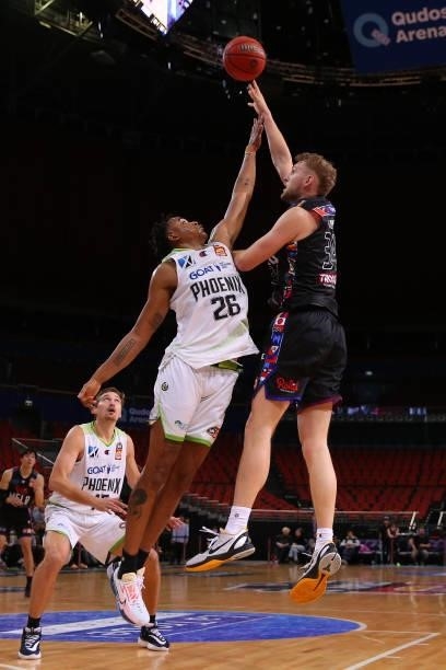 Jock Landale of United drives to the basket under pressure from Ben Moore of the Phoenix during game three of the NBL Semi-Final Series between...