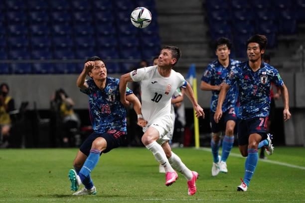 Mirlan Murzaev of Kyrgyz and Shinnosuke Nakatani of Japan compete for the ball during the FIFA World Cup Asian Qualifier second round Group F match...