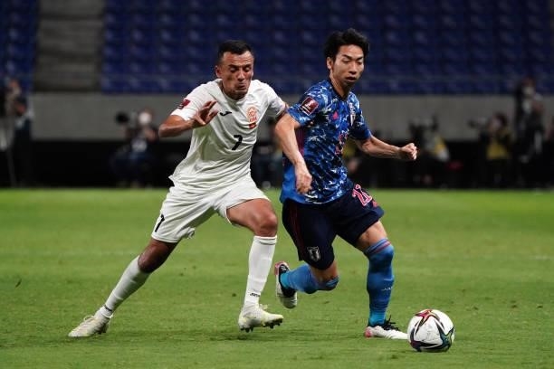 Hayao Kawabe of Japan and Tursunali Rustamov of Kyrgyz compete for the ball during the FIFA World Cup Asian Qualifier second round Group F match...