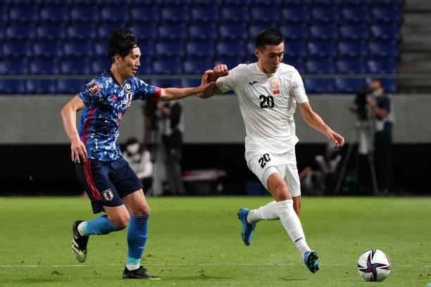 Baktyiar Duishobekov of Kyrgyz and Genki Haraguchi of Japan compete for the ball during the FIFA World Cup Asian Qualifier second round Group F match...