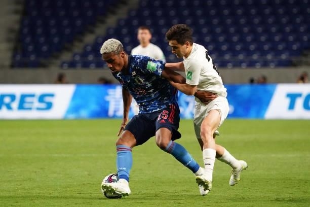 Ado Onaiwu of Japan and Alimardon Shukurov of Kyrgyz compete for the ball during the FIFA World Cup Asian Qualifier second round Group F match...