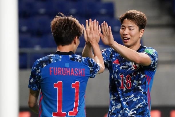 Takuma Asano of Japan celebrates scoring his side's fifth goal with his team mate Kyogo Furuhashi during the FIFA World Cup Asian Qualifier second...