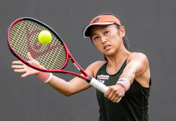 Misaki Doi of Japan hits a backhand against Angelique Kerber of Germany in the women's singles match during day 4 of the bett1open at LTTC Rot-Weiß...
