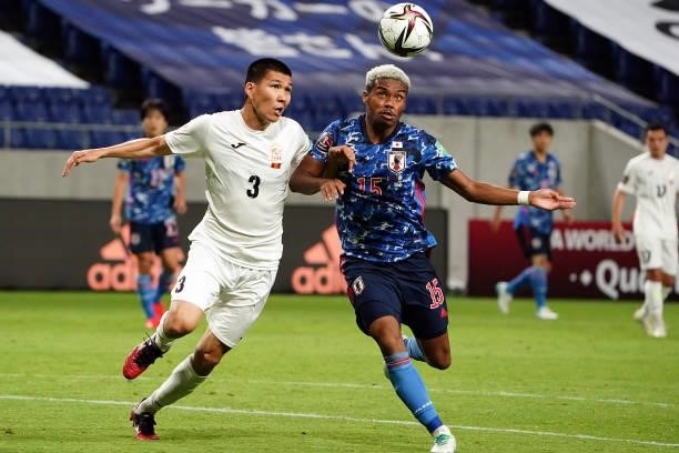 Ado Onaiwu of Japan and Tamirlan Kozubaev of Kyrgyz compete for the ball during the FIFA World Cup Asian Qualifier 2nd round Group F match between...