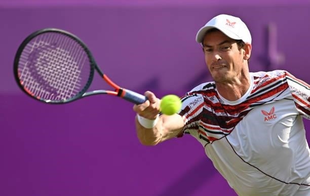 Andy Murray of Great Britain stretches to play a forehand during his First Round match against Benoît Paire of France during Day 2 of the cinch...