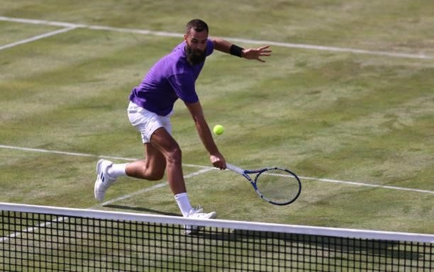 Benoît Paire of France stretches to play a backhand during his First Round match against Andy Murray of Great Britain during Day 2 of the cinch...