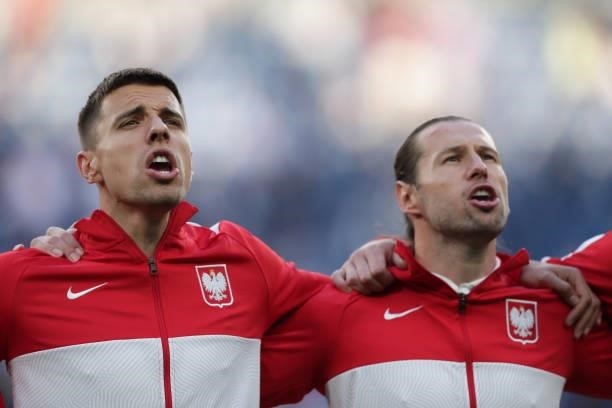 Jan Bednarek and his teammate Grzegorz Krychowiak of Poland sing their national anthem prior to start during the UEFA Euro 2020 Championship Group E...