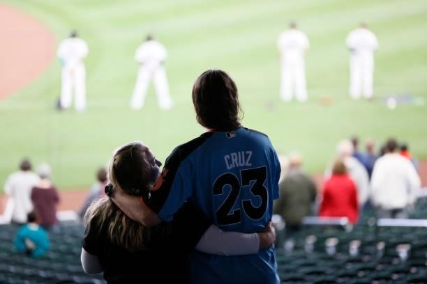 Fans stand for the national anthem before the game between the Seattle Mariners and the Minnesota Twins at T-Mobile Park on June 14, 2021 in Seattle,...