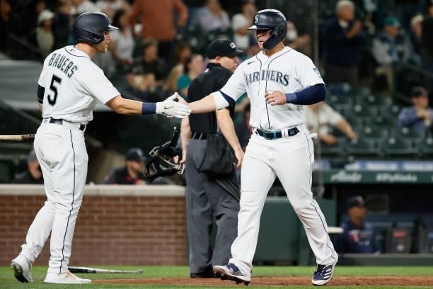 Jake Bauers and Ty France of the Seattle Mariners react after a run against the Minnesota Twins during the fifth inning at T-Mobile Park on June 14,...