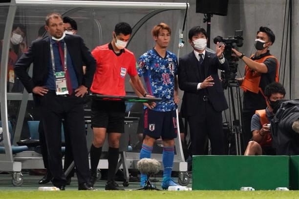 Japan head coach Hajime Moriyasu gives instruction to Sho Sasaki during the FIFA World Cup Asian Qualifier 2nd round Group F match between Japan and...