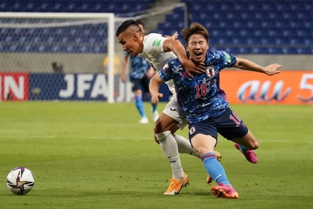 Takuma Asano of Japan and Kairat Zhyrgalbek Uulu of Kyrgyz compete for the ball during the FIFA World Cup Asian Qualifier 2nd round Group F match...